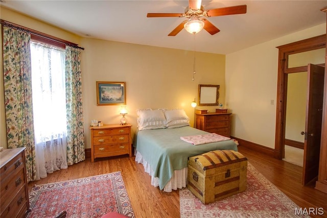 619 E Main St, Carlinville, IL 62626 - bedroom with light wood-style floors, baseboards, and ceiling fan