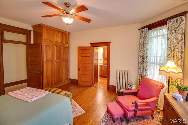 619 E Main St, Carlinville, IL 62626 - bedroom featuring radiator heating unit, light wood-style flooring, baseboards, and a ceiling fan