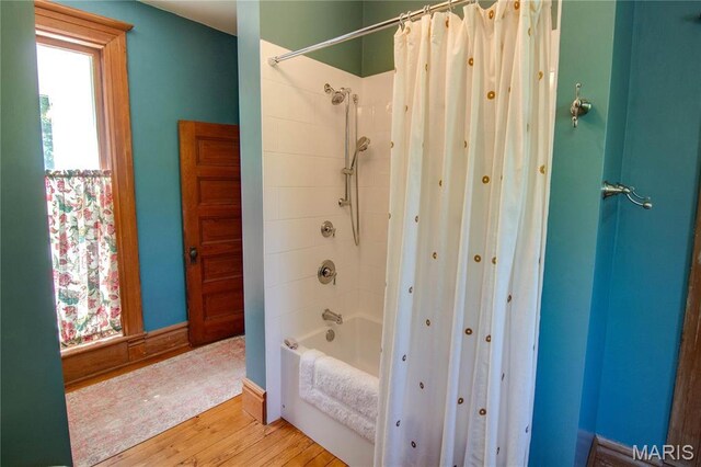 619 E Main St, Carlinville, IL 62626 - bathroom featuring healthy amount of natural light, wood finished floors, and shower / tub combo with curtain