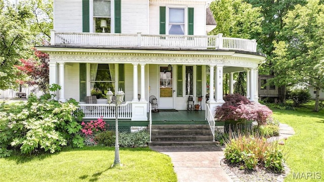 619 E Main St, Carlinville, IL 62626 - view of front facade with a porch and a front yard