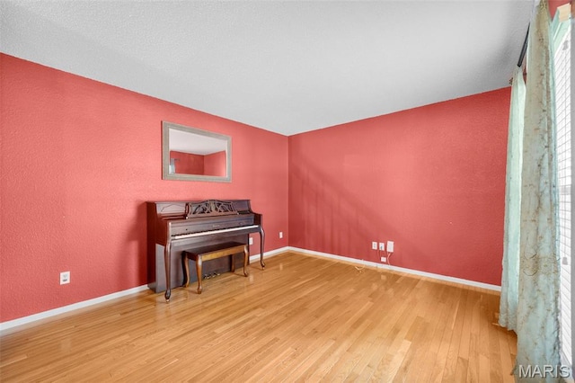 14 Sunderland Ct, Saint Charles, MO 63303 - sitting room featuring wood finished floors, baseboards, and a textured wall