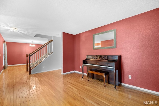 14 Sunderland Ct, Saint Charles, MO 63303 - living area featuring wood-type flooring, a chandelier, stairway, baseboards, and a textured wall