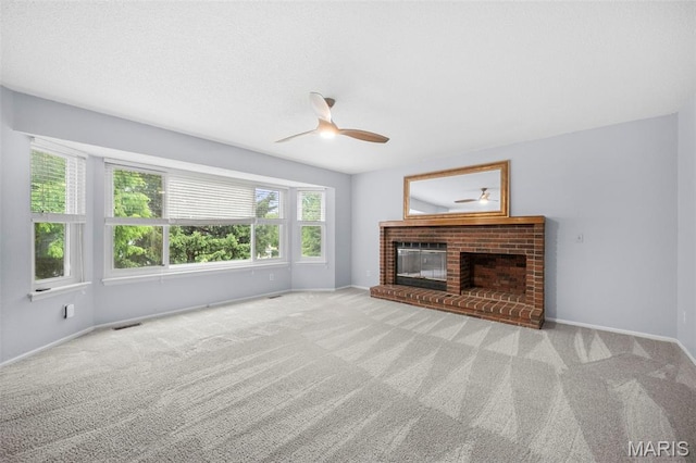 14 Sunderland Ct, Saint Charles, MO 63303 - unfurnished living room featuring a ceiling fan, carpet, a brick fireplace, and baseboards