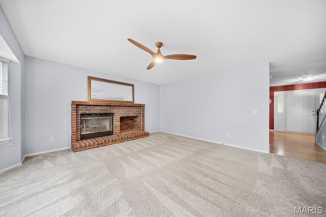 14 Sunderland Ct, Saint Charles, MO 63303 - unfurnished living room with carpet, a ceiling fan, a fireplace, and baseboards