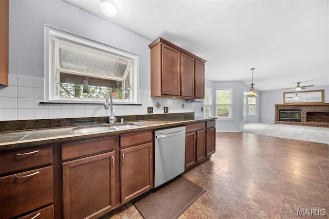 14 Sunderland Ct, Saint Charles, MO 63303 - kitchen featuring stainless steel dishwasher, a sink, dark countertops, tasteful backsplash, and open floor plan