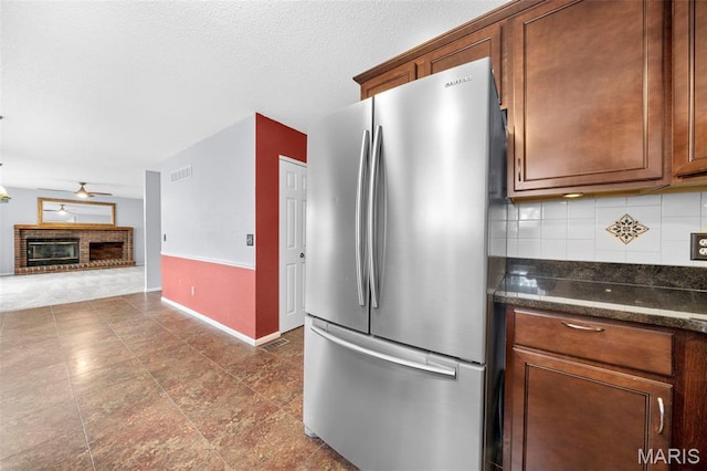 14 Sunderland Ct, Saint Charles, MO 63303 - kitchen featuring freestanding refrigerator, tasteful backsplash, ceiling fan, open floor plan, and baseboards