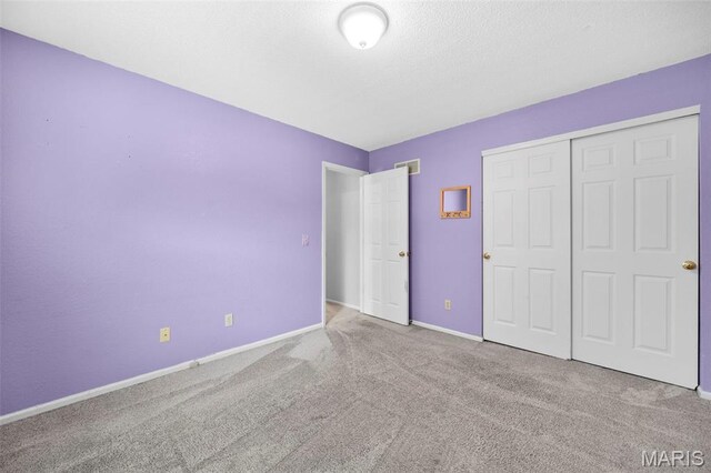 14 Sunderland Ct, Saint Charles, MO 63303 - unfurnished bedroom featuring carpet, baseboards, and a closet