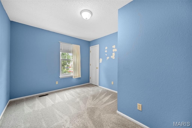 14 Sunderland Ct, Saint Charles, MO 63303 - unfurnished room with carpet flooring, a textured ceiling, and baseboards