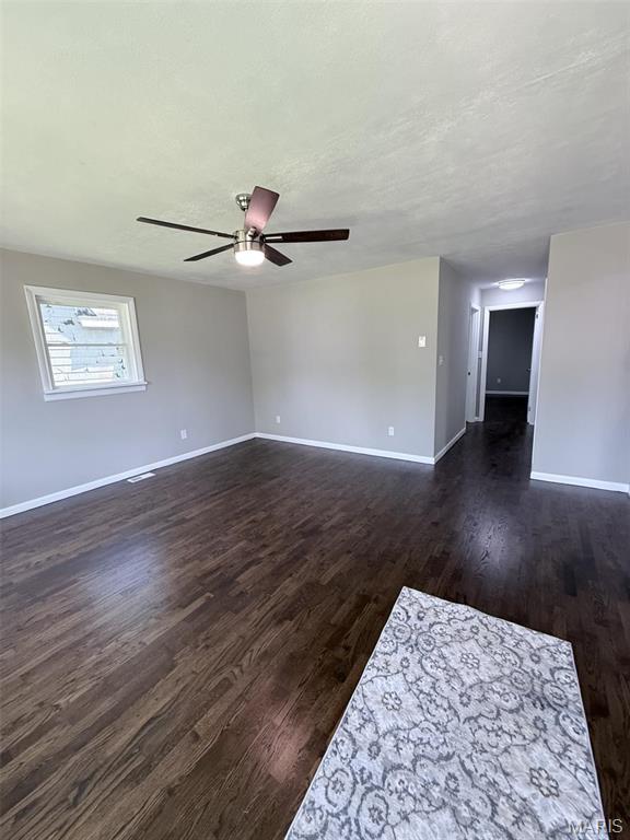 170 E Euclid Ave, Sullivan, MO 63080 - empty room with baseboards, a ceiling fan, and dark wood finished floors