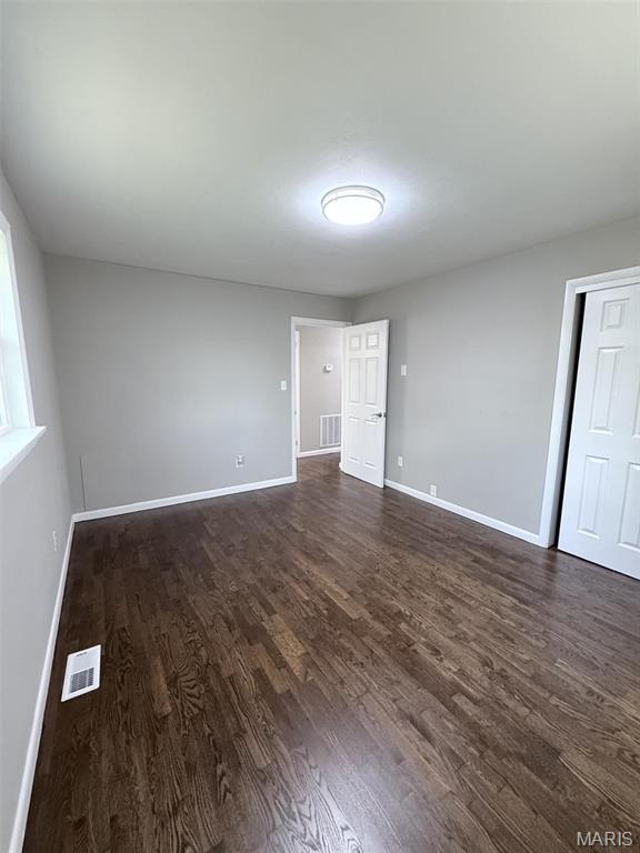 170 E Euclid Ave, Sullivan, MO 63080 - unfurnished room featuring baseboards and dark wood finished floors