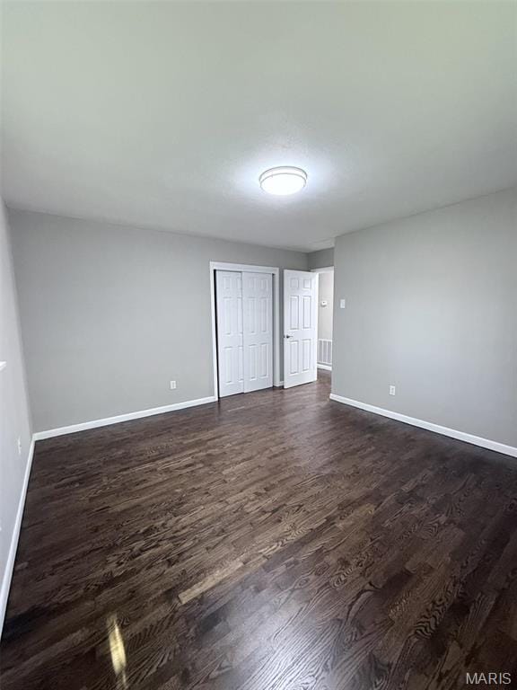 170 E Euclid Ave, Sullivan, MO 63080 - unfurnished bedroom featuring dark wood-style floors, baseboards, and a closet