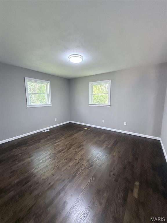 170 E Euclid Ave, Sullivan, MO 63080 - unfurnished room featuring healthy amount of natural light, baseboards, and dark wood finished floors