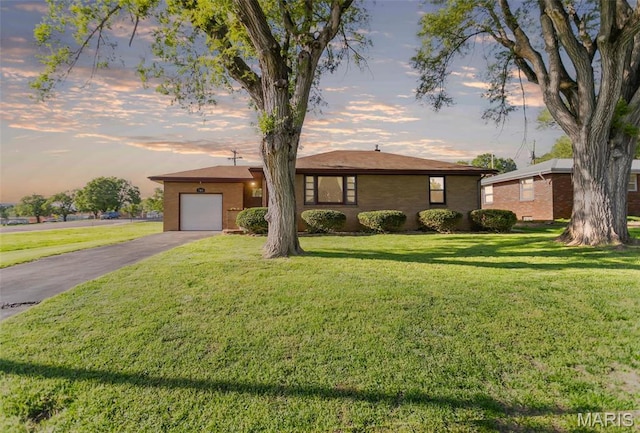 703 Ridgeway, East Alton, IL 62024 - ranch-style house with asphalt driveway, a front yard, and an attached garage