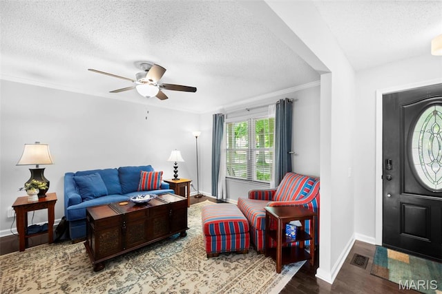 207 Straightoak, Ballwin, MO 63021 - living room with a textured ceiling, wood finished floors, a ceiling fan, baseboards, and ornamental molding