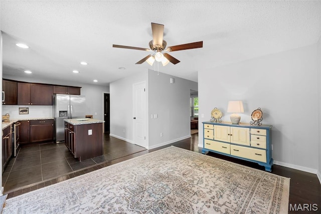 207 Straightoak, Ballwin, MO 63021 - kitchen featuring stainless steel refrigerator with ice dispenser, a kitchen island, dark brown cabinetry, recessed lighting, and ceiling fan