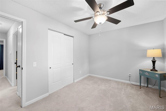 207 Straightoak, Ballwin, MO 63021 - unfurnished bedroom with carpet floors, baseboards, a closet, a textured ceiling, and a ceiling fan
