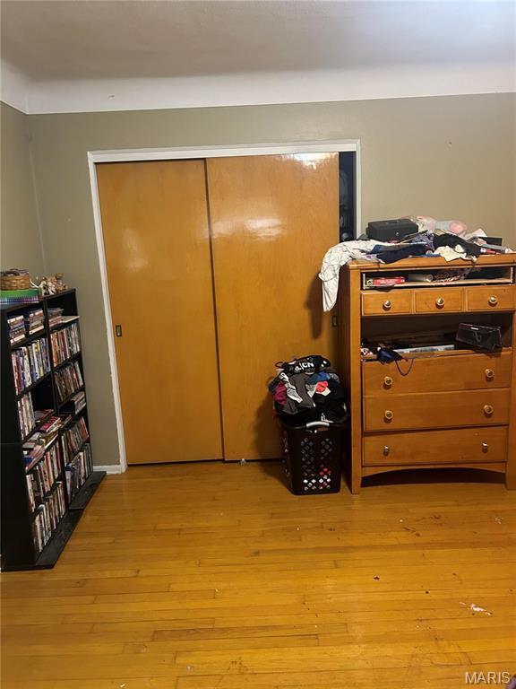 bedroom featuring light wood-style floors and a closet
