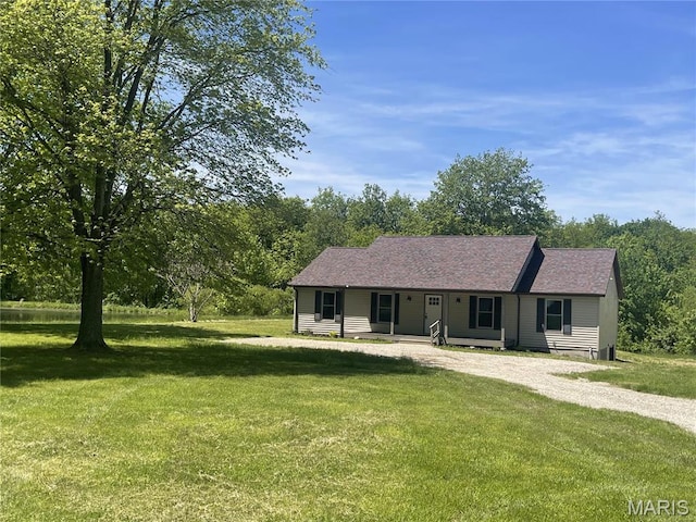 ranch-style home featuring driveway, a front yard, and a porch