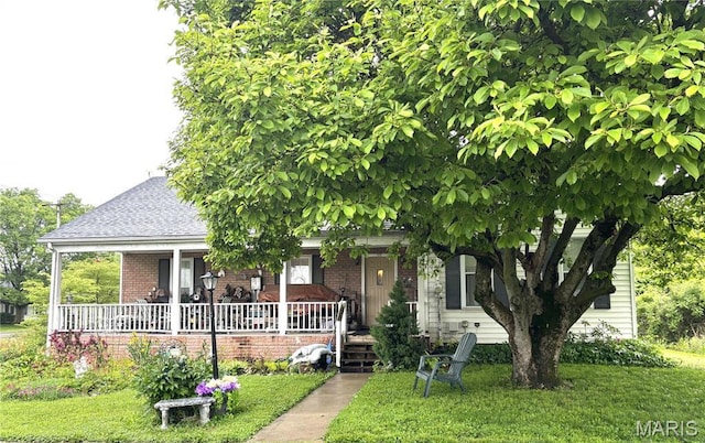 919 S 5th St, Greenville, IL 62246 - obstructed view of property featuring covered porch, brick siding, a front lawn, and a shingled roof