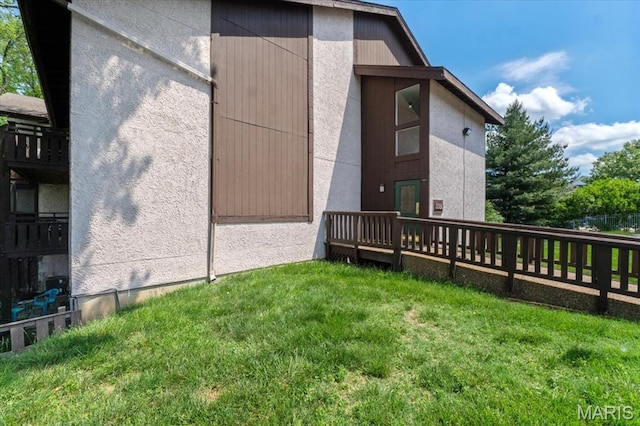 view of home's exterior featuring a yard and a wooden deck