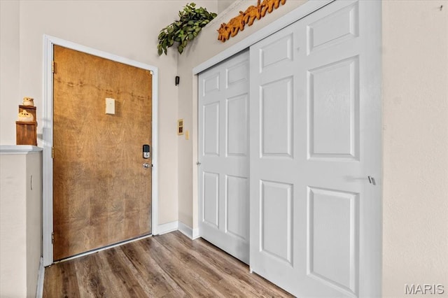 entryway with wood finished floors and baseboards