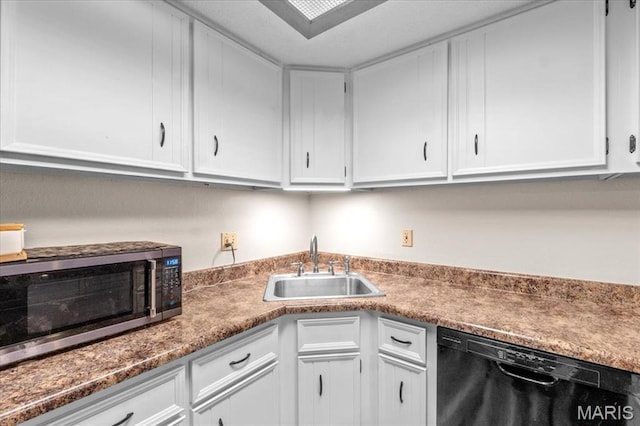 kitchen featuring dishwasher, stainless steel microwave, a sink, and white cabinets