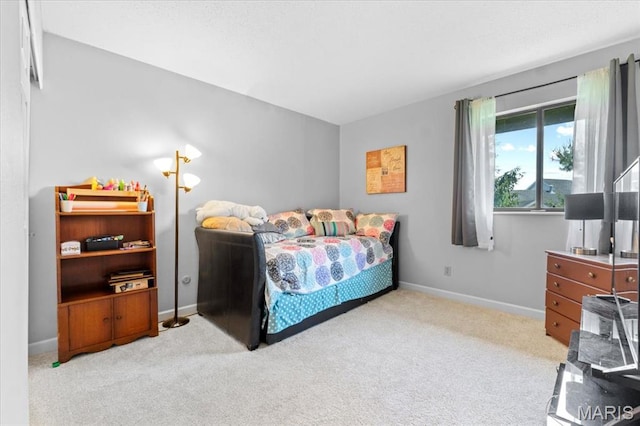 bedroom with carpet flooring and baseboards