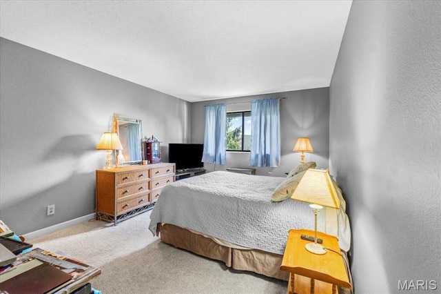 bedroom featuring carpet floors and baseboards