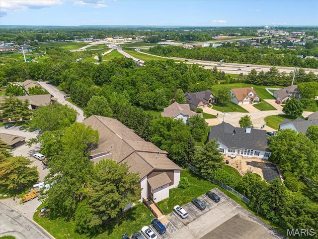 aerial perspective of suburban area featuring a tree filled landscape