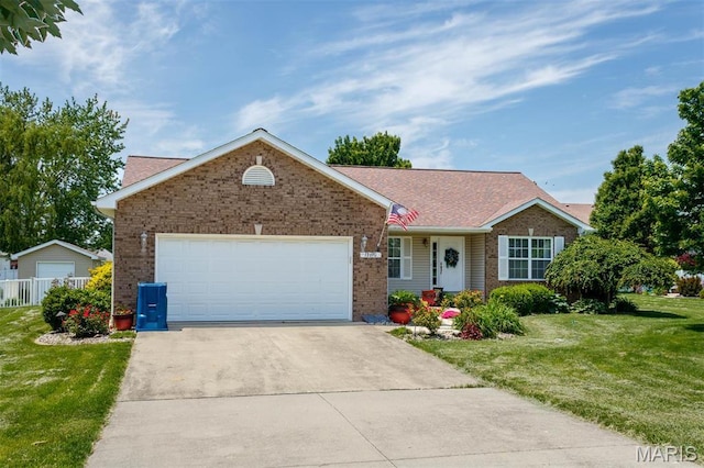 ranch-style home with brick siding, a front lawn, an attached garage, and driveway