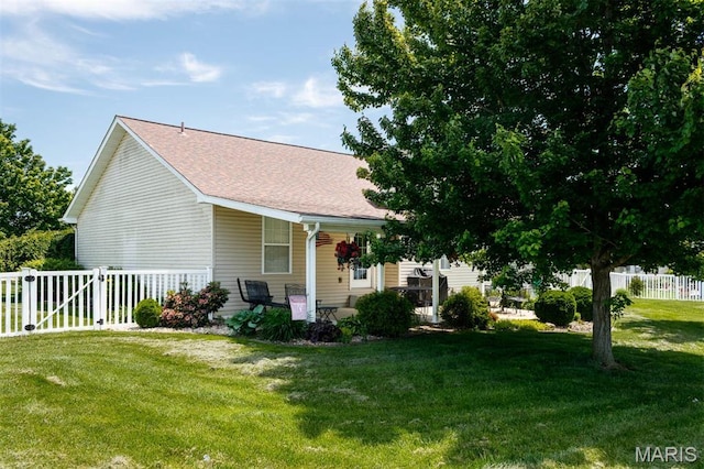 view of side of property featuring a shingled roof and covered porch