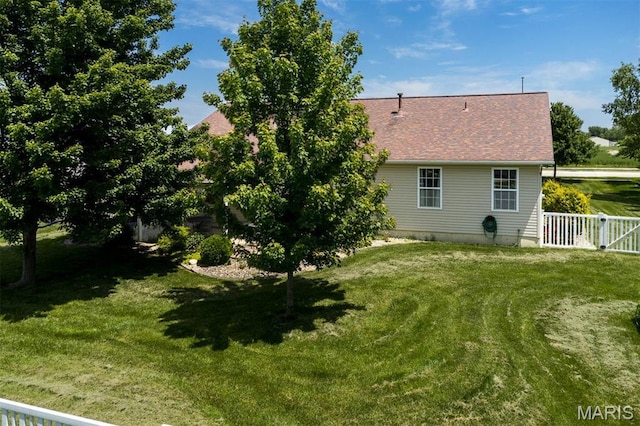 back of house with a shingled roof