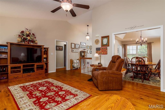 living room featuring a chandelier, wood finished floors, ceiling fan, and high vaulted ceiling