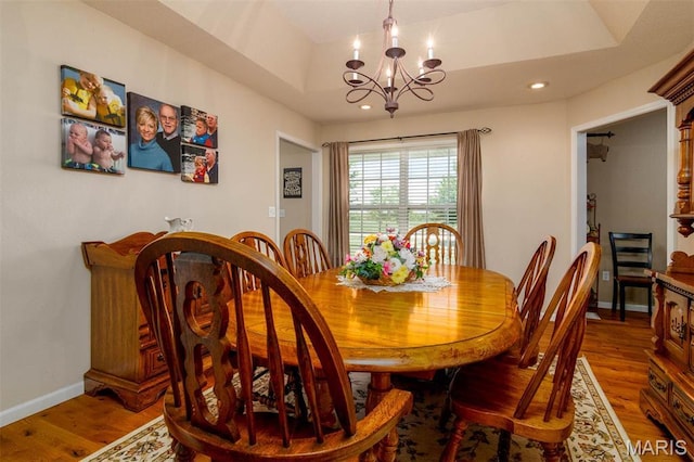 dining room featuring a chandelier, wood finished floors, baseboards, and recessed lighting