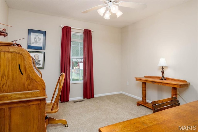 office featuring carpet floors, ceiling fan, and baseboards