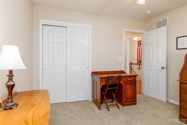office featuring light colored carpet and a ceiling fan