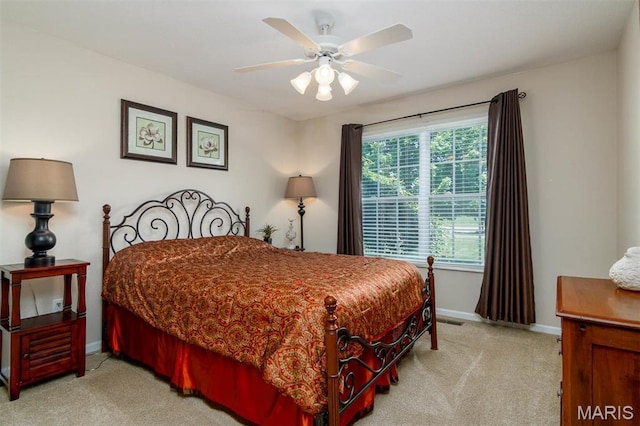 carpeted bedroom featuring baseboards and ceiling fan