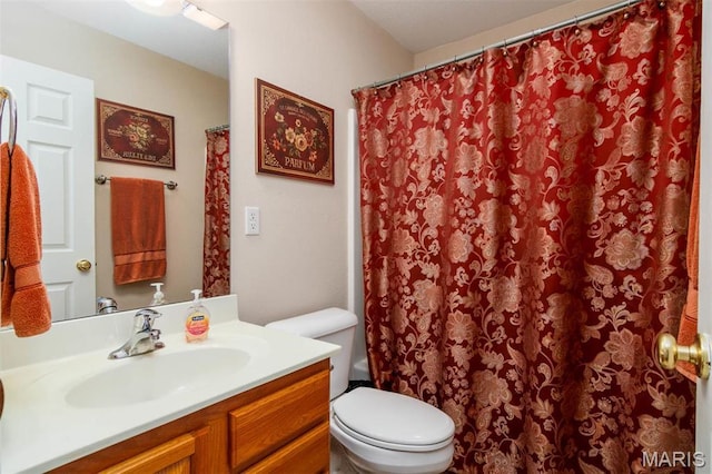 full bath featuring toilet, vanity, and curtained shower