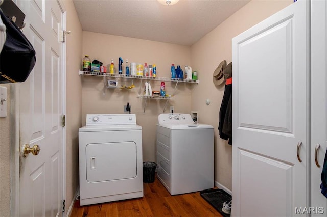 laundry room with independent washer and dryer, wood finished floors, and a textured ceiling