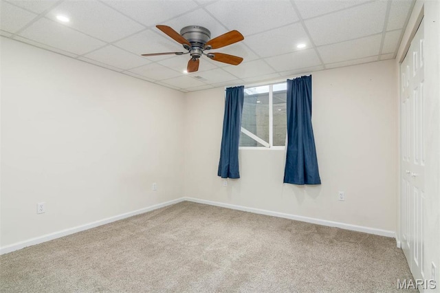 carpeted empty room with ceiling fan, baseboards, a paneled ceiling, and recessed lighting