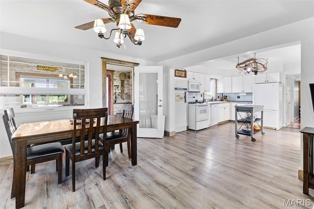 5704 Feezor Rd, Farmington, MO 63640 - dining room featuring a ceiling fan, light wood-style flooring, a chandelier, and baseboards