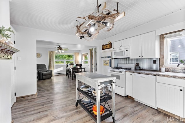 5704 Feezor Rd, Farmington, MO 63640 - kitchen with white appliances, a sink, healthy amount of natural light, and white cabinetry