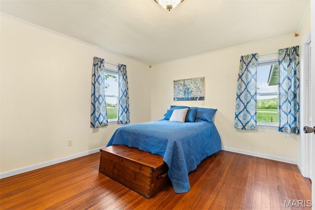5704 Feezor Rd, Farmington, MO 63640 - bedroom with multiple windows, hardwood / wood-style flooring, and baseboards