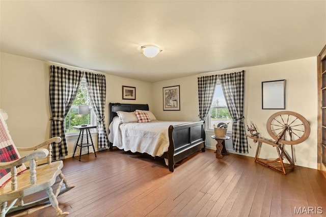 5704 Feezor Rd, Farmington, MO 63640 - bedroom featuring multiple windows, wood-type flooring, and baseboards