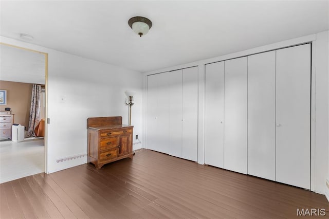 5704 Feezor Rd, Farmington, MO 63640 - unfurnished bedroom featuring two closets and wood finished floors