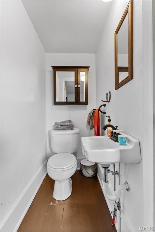 5704 Feezor Rd, Farmington, MO 63640 - half bath with toilet, baseboards, wood finished floors, and a sink