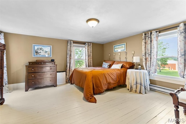 5704 Feezor Rd, Farmington, MO 63640 - bedroom with a baseboard radiator and light wood finished floors