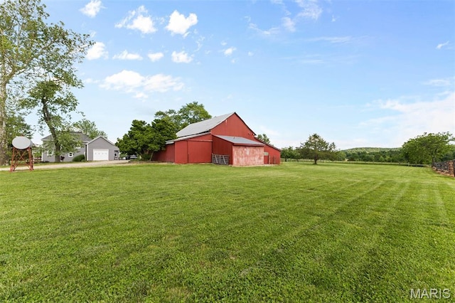 5704 Feezor Rd, Farmington, MO 63640 - view of green lawn with a detached garage, a barn, and an outdoor structure