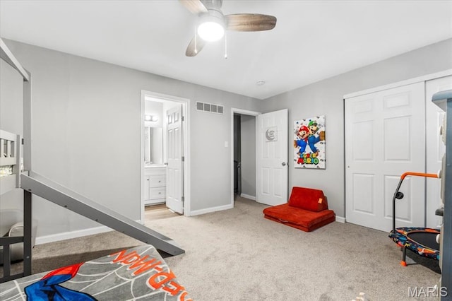 workout room featuring carpet flooring, ceiling fan, and baseboards