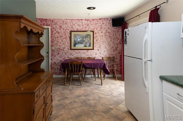 14 Dee St, Moro, IL 62067 - dining space with wallpapered walls, baseboards, and stone finish floors